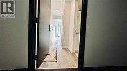 Corridor featuring light wood-style floors -