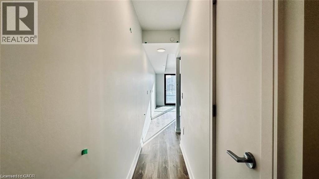 Corridor with wood finished floors and baseboards - 1 Jarvis Street Unit# 509, Hamilton, ON - Indoor