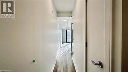 Corridor with wood finished floors and baseboards -