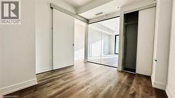 Unfurnished bedroom with dark wood-style flooring and multiple closets -