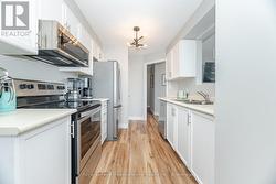 Galley Kitchen With Stainless Appliances -