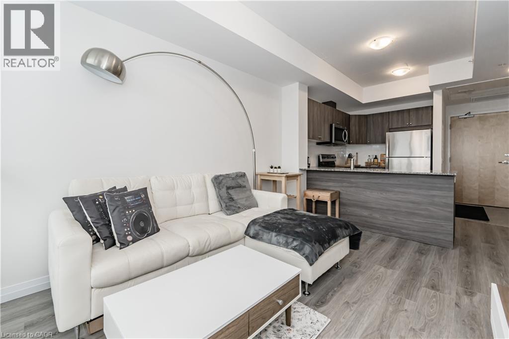 Living room with light wood-style flooring - 60 Charles Street Unit# 2003, Kitchener, ON - Indoor