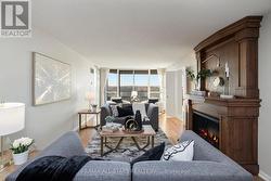 Living room w electric fireplace and pond view. -