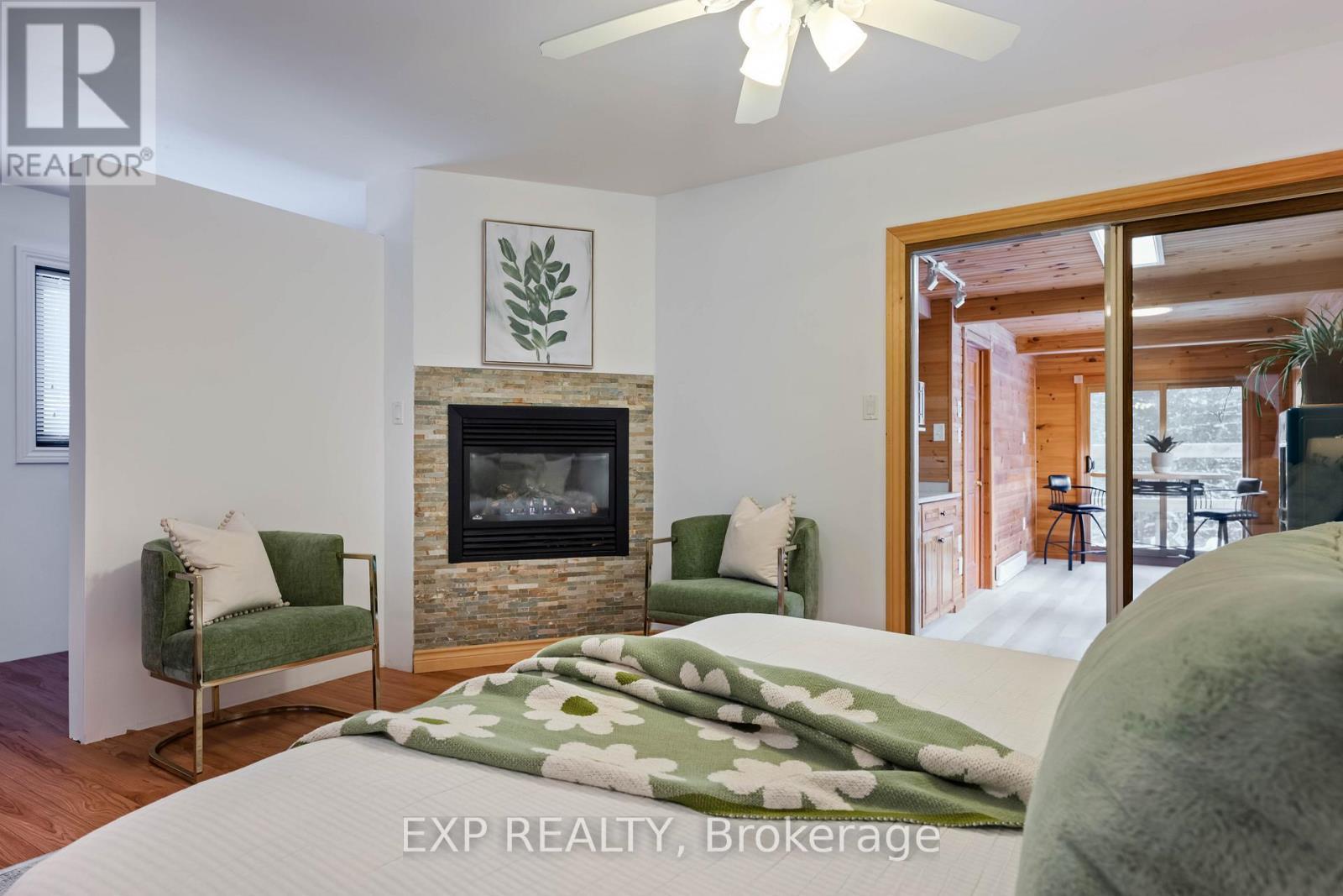Primary Suite - 213037 10Th Line, Amaranth, ON - Indoor Photo Showing Bedroom With Fireplace