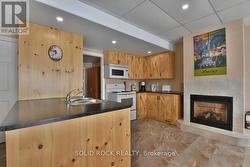 Gas fireplace between kitchen & dining area -