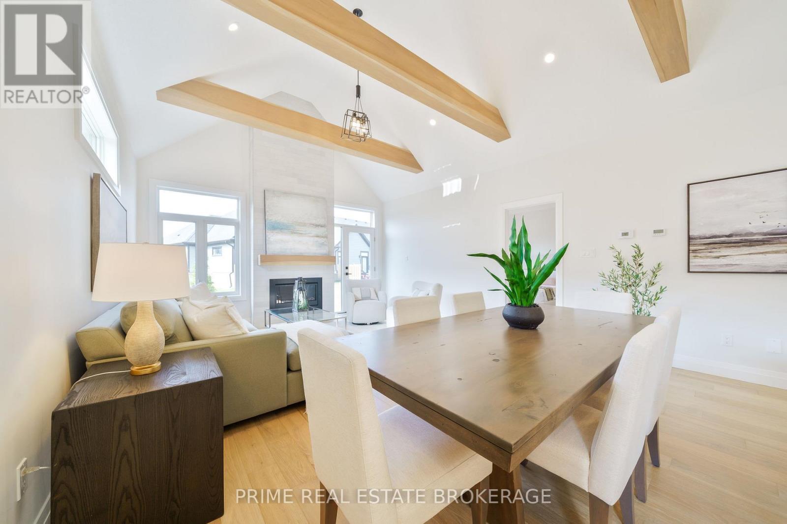 44 - 63 Compass Trail, Central Elgin, ON - Indoor Photo Showing Dining Room With Fireplace