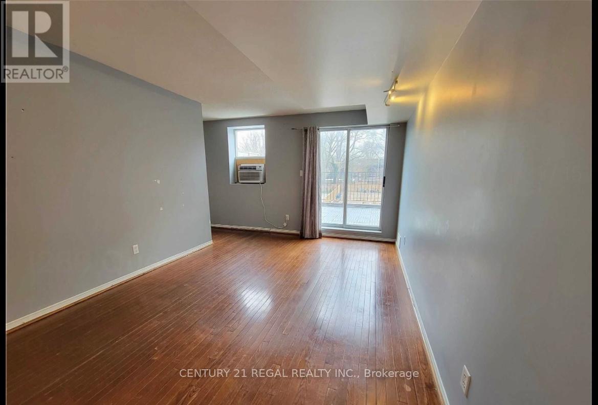Living room look toward balcony - #2 - 1289 Queen Street W, Toronto, ON