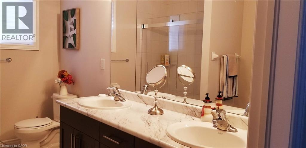 Bathroom with double vanity and a stall shower - 118 Steeplechase Way, Waterloo, ON - Indoor Photo Showing Bathroom