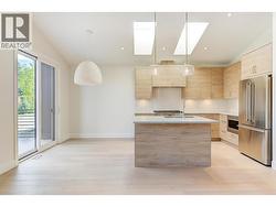 The kitchen is both stylish and functional, featuring a large sit-up island -