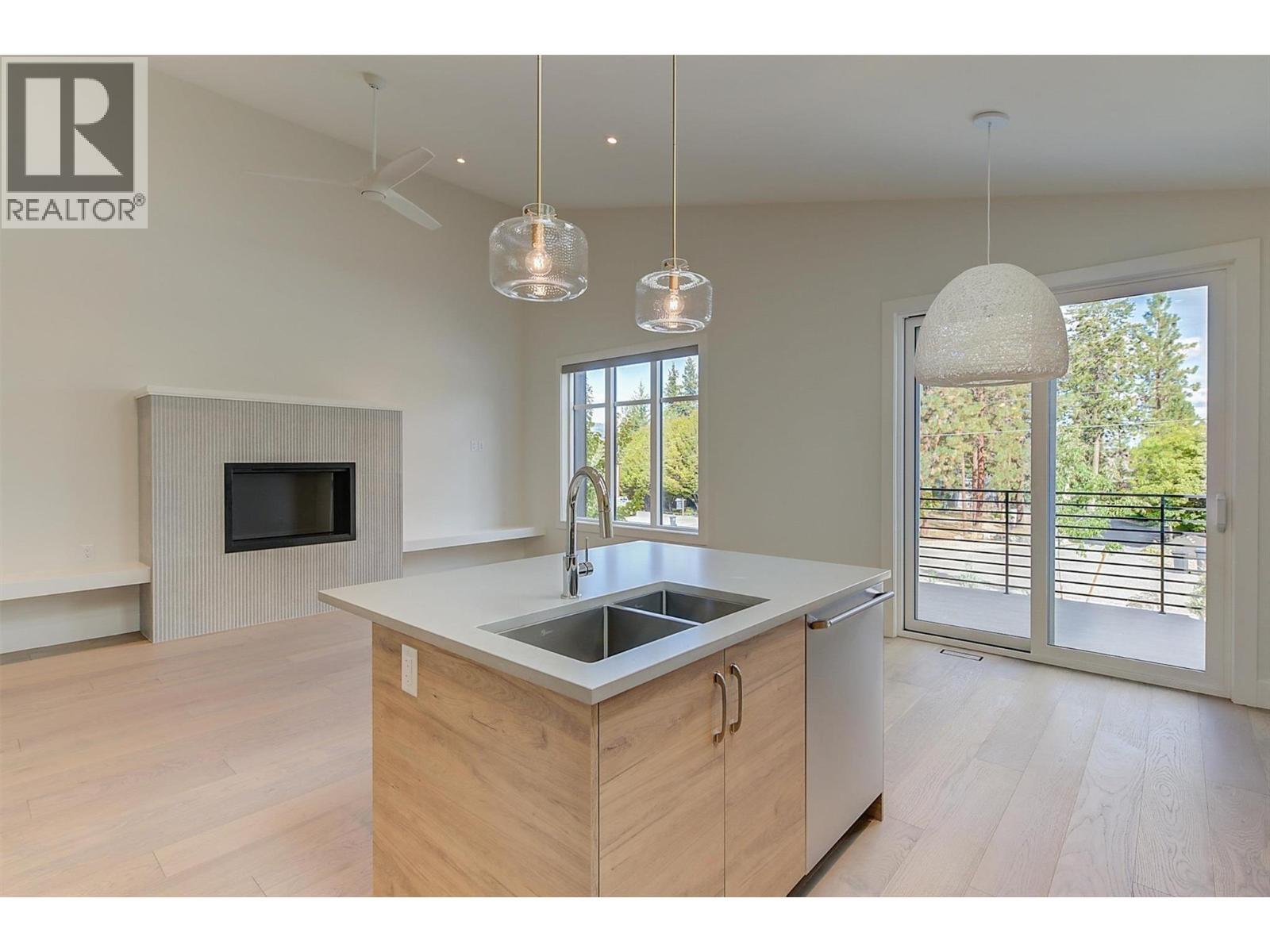 761 Barnaby Road, Kelowna, BC - Indoor Photo Showing Kitchen With Fireplace With Double Sink