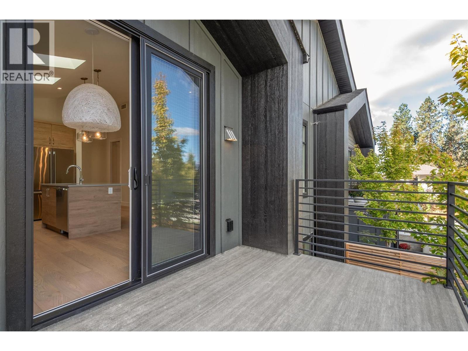 Sliding glass doors allowing extra light to flood the main floor - 761 Barnaby Road, Kelowna, BC - Outdoor With Exterior