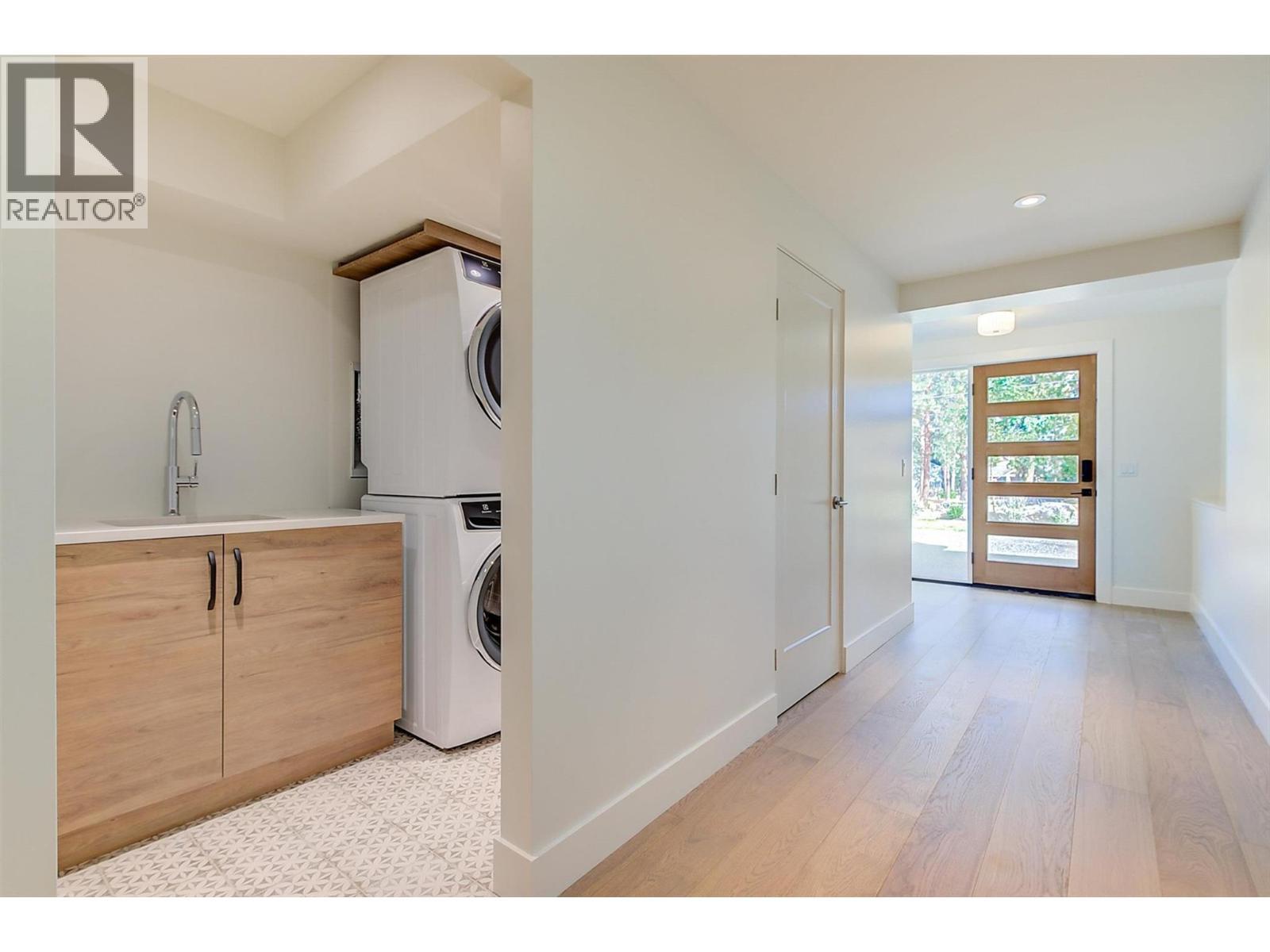 laundry room with sliding barn-style door - 761 Barnaby Road, Kelowna, BC - Indoor Photo Showing Laundry Room
