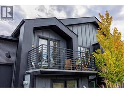 Main level porch off of kitchen with custom wrought iron railings -