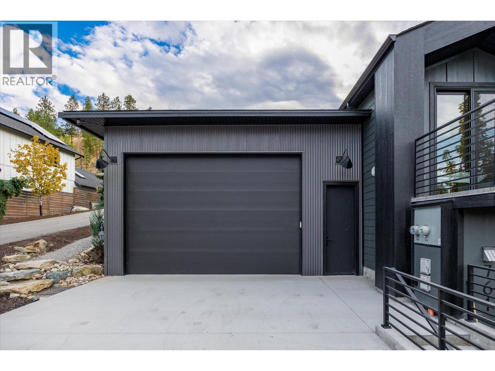 OVERSIZE DOUBLE GARAGE — perfect for your boat, RV, or extra storage. - 761 Barnaby Road, Kelowna, BC - Outdoor With Exterior