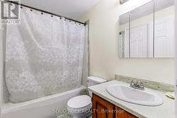 4-piece bathroom with modern tub enclosure -