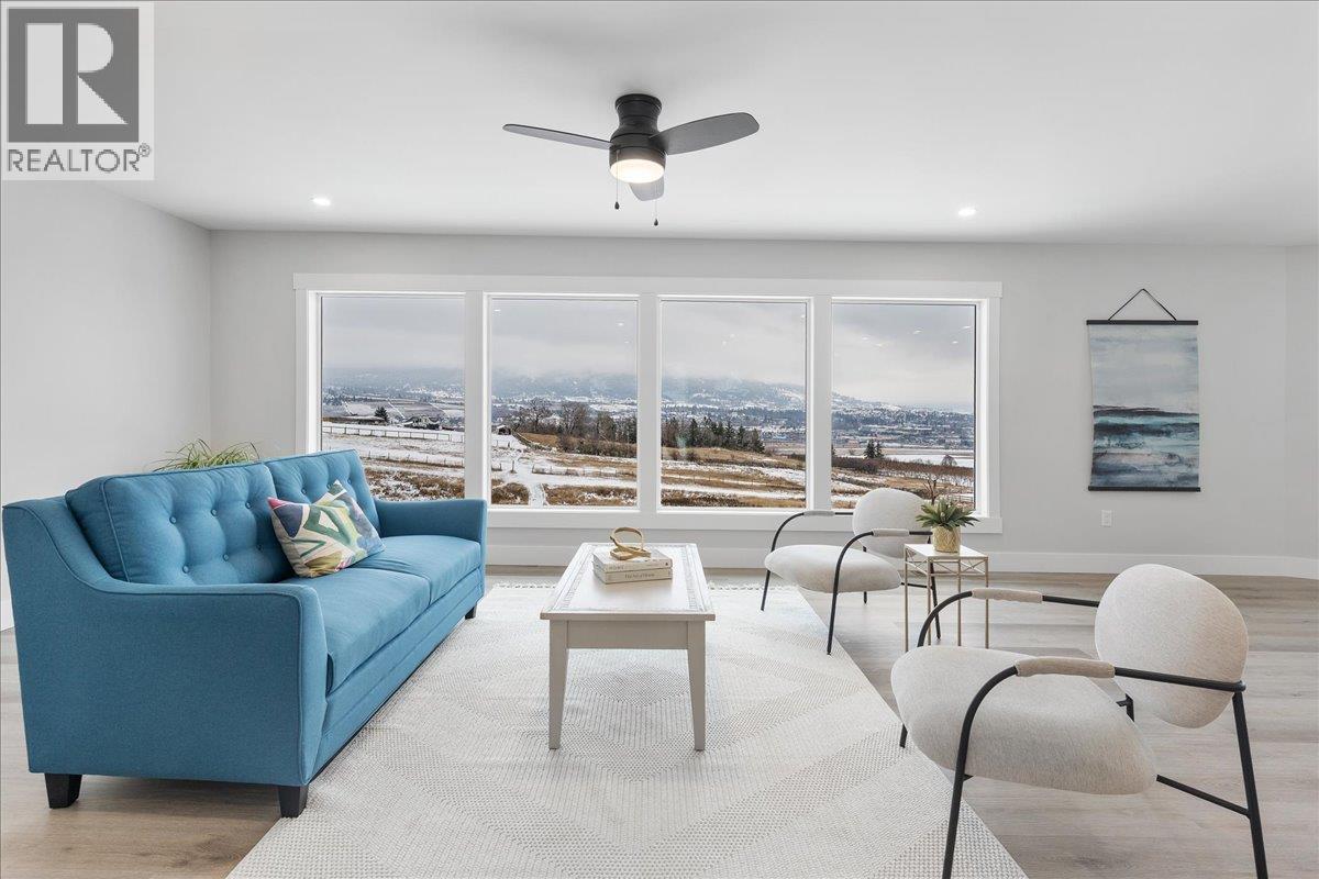 Large windows with unobstructed view - 6535 Blue Jay Road, Vernon, BC - Indoor Photo Showing Living Room