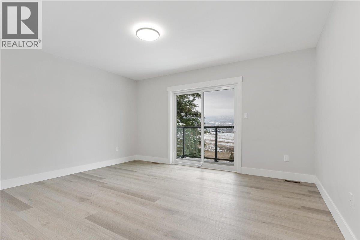 Second Bedroom with small sittng patio - 6535 Blue Jay Road, Vernon, BC - Indoor Photo Showing Other Room