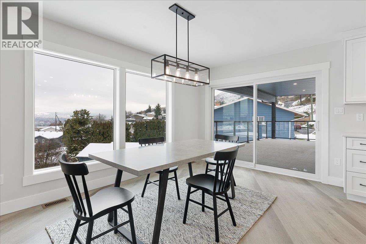 Dining & Kitchen access to large covered deck - 6535 Blue Jay Road, Vernon, BC - Indoor Photo Showing Dining Room