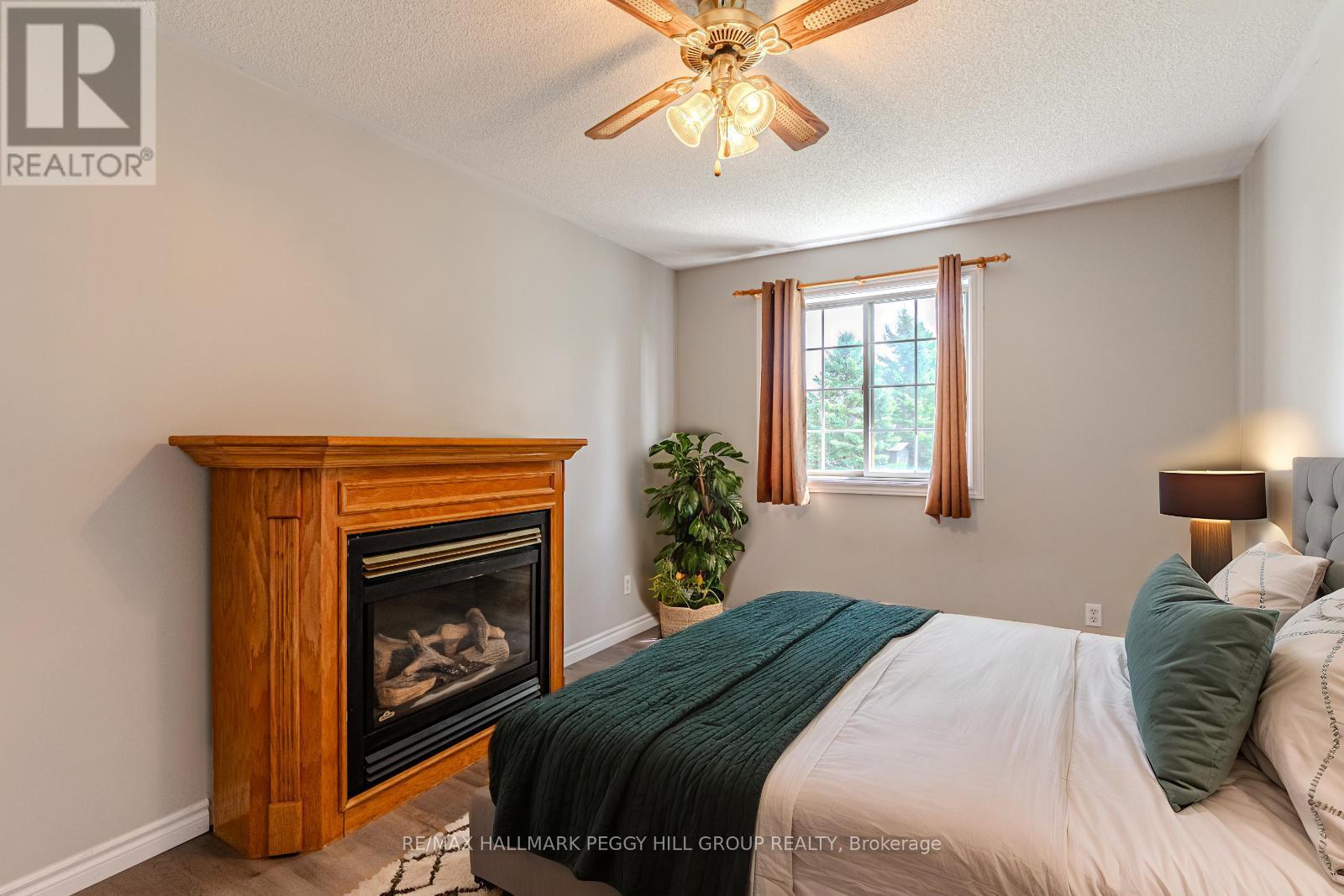 55 Marlow Circle, Springwater, ON - Indoor Photo Showing Bedroom With Fireplace