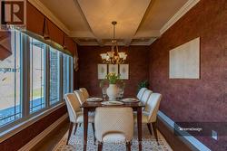 Formal dining room with coffered ceilings. -