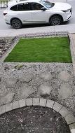 Low-maintenance front yard with artificial grass -
