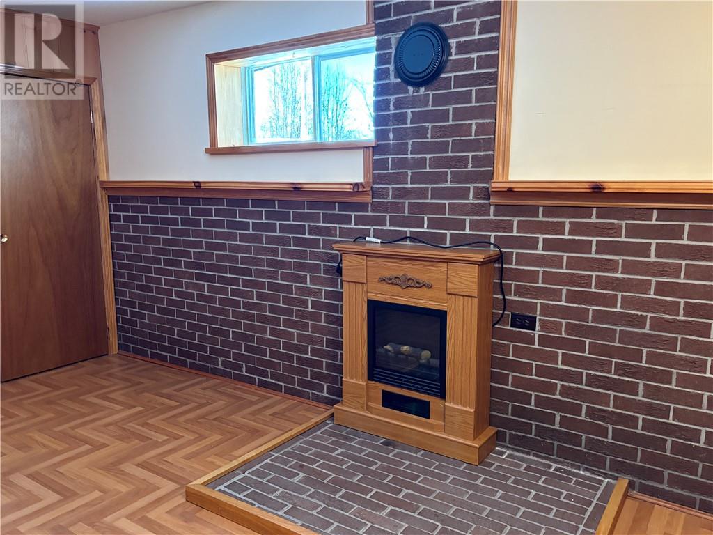 27 Tilley, Killarney, ON - Indoor Photo Showing Other Room With Fireplace