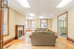 Com space: has original flooring and fireplace -