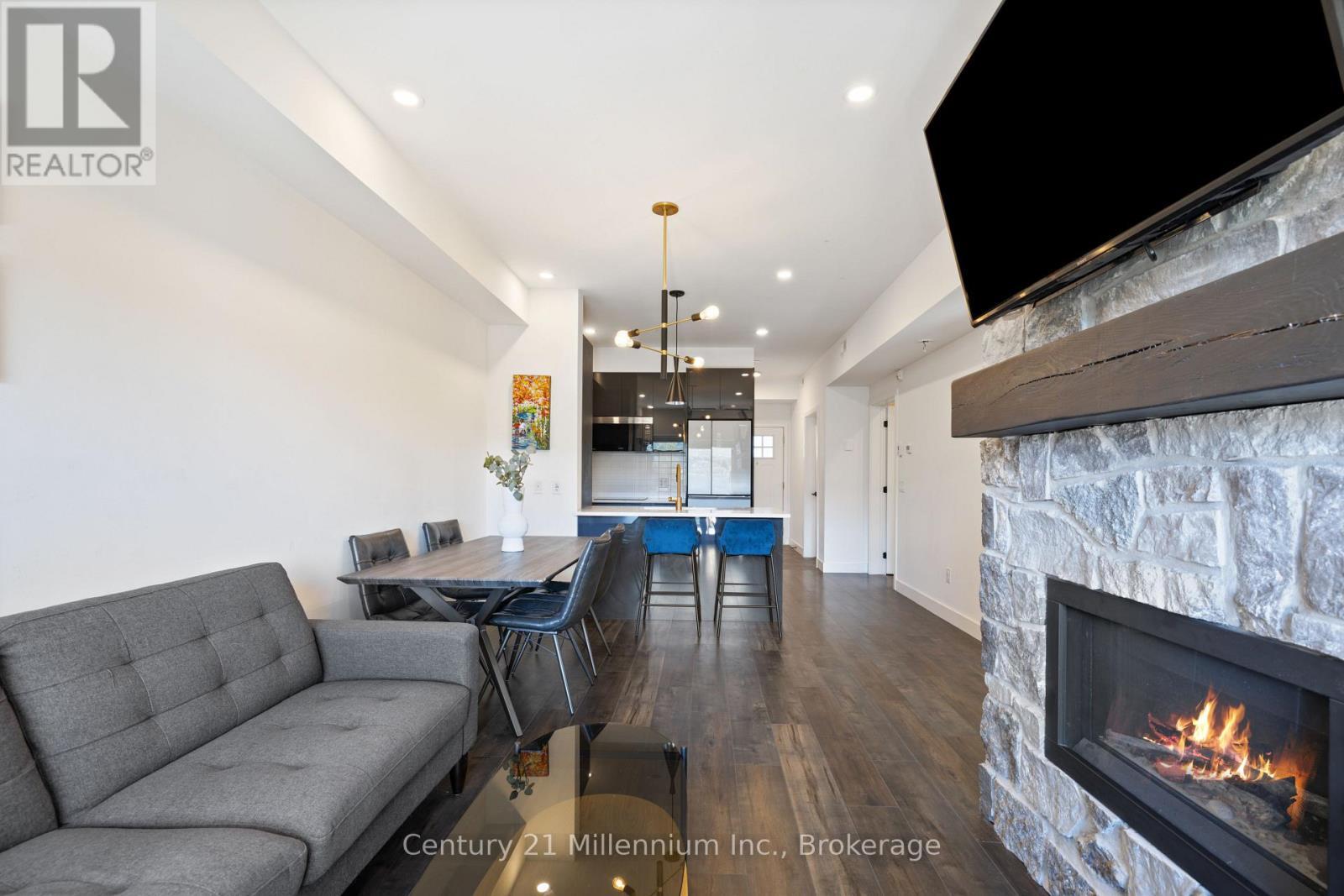 306 - 20 Beckwith Lane, Blue Mountains, ON - Indoor Photo Showing Living Room With Fireplace