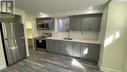 Sleek Kitchen - Quartz Counter & Tiled Backsplash -