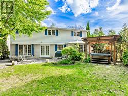Private backyard features hot tub and pergola -