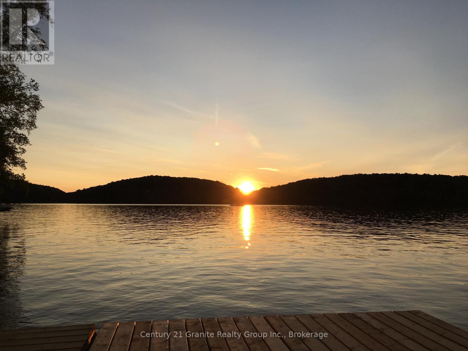 Sunset from Dock - 1119 Wampum Road, Dysart Et Al (Dudley), ON - Outdoor With Body Of Water With View