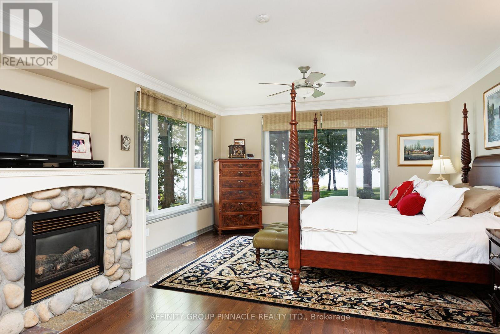 12 Edgewood Drive, Kawartha Lakes (Verulam), ON - Indoor Photo Showing Bedroom With Fireplace
