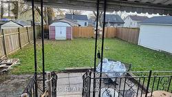 fully fenced back yard with patio and storage shed -