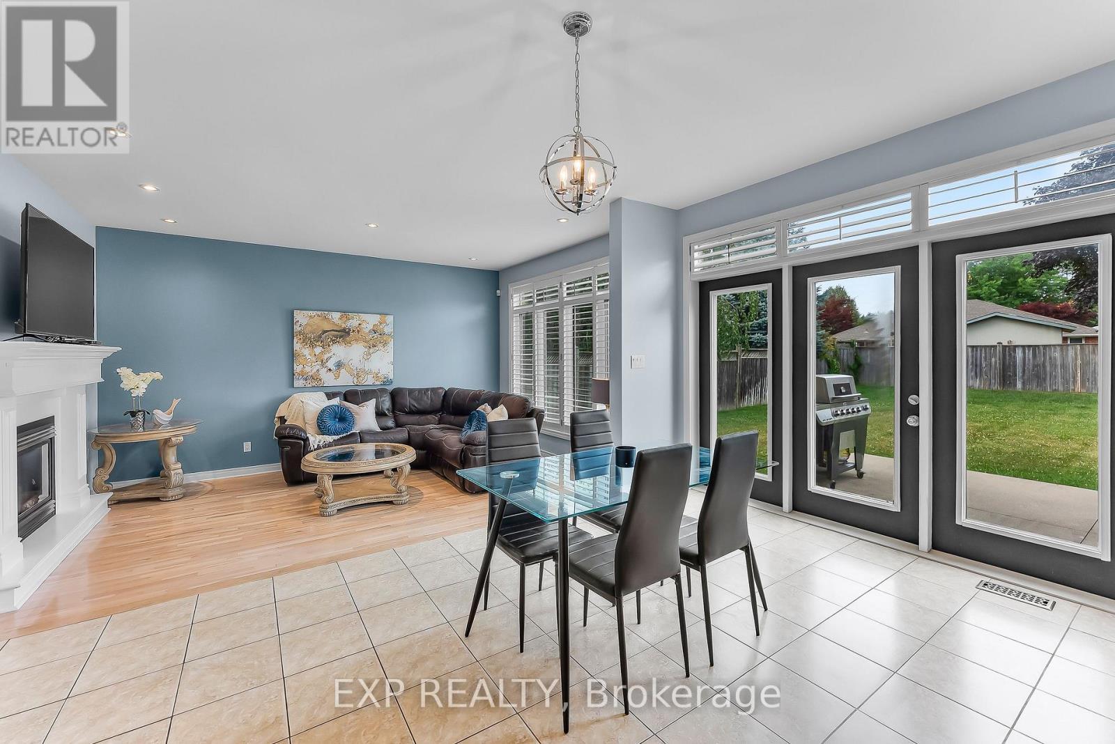 Glass Doors to Backyard Patio - 7847 Cathedral Drive, Niagara Falls (Mt. Carmel), ON - Indoor With Fireplace