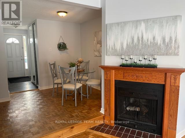 E - 14 Larkshire Lane, Ottawa, ON - Indoor Photo Showing Living Room With Fireplace