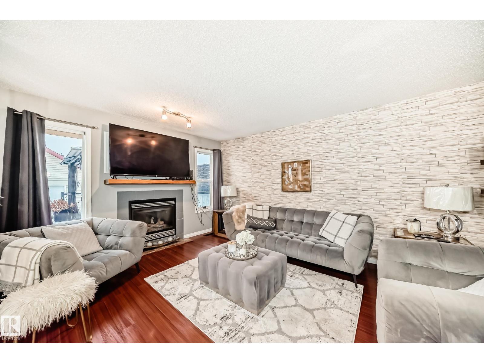 5819 Sutter Pl Nw, Edmonton, AB - Indoor Photo Showing Living Room With Fireplace