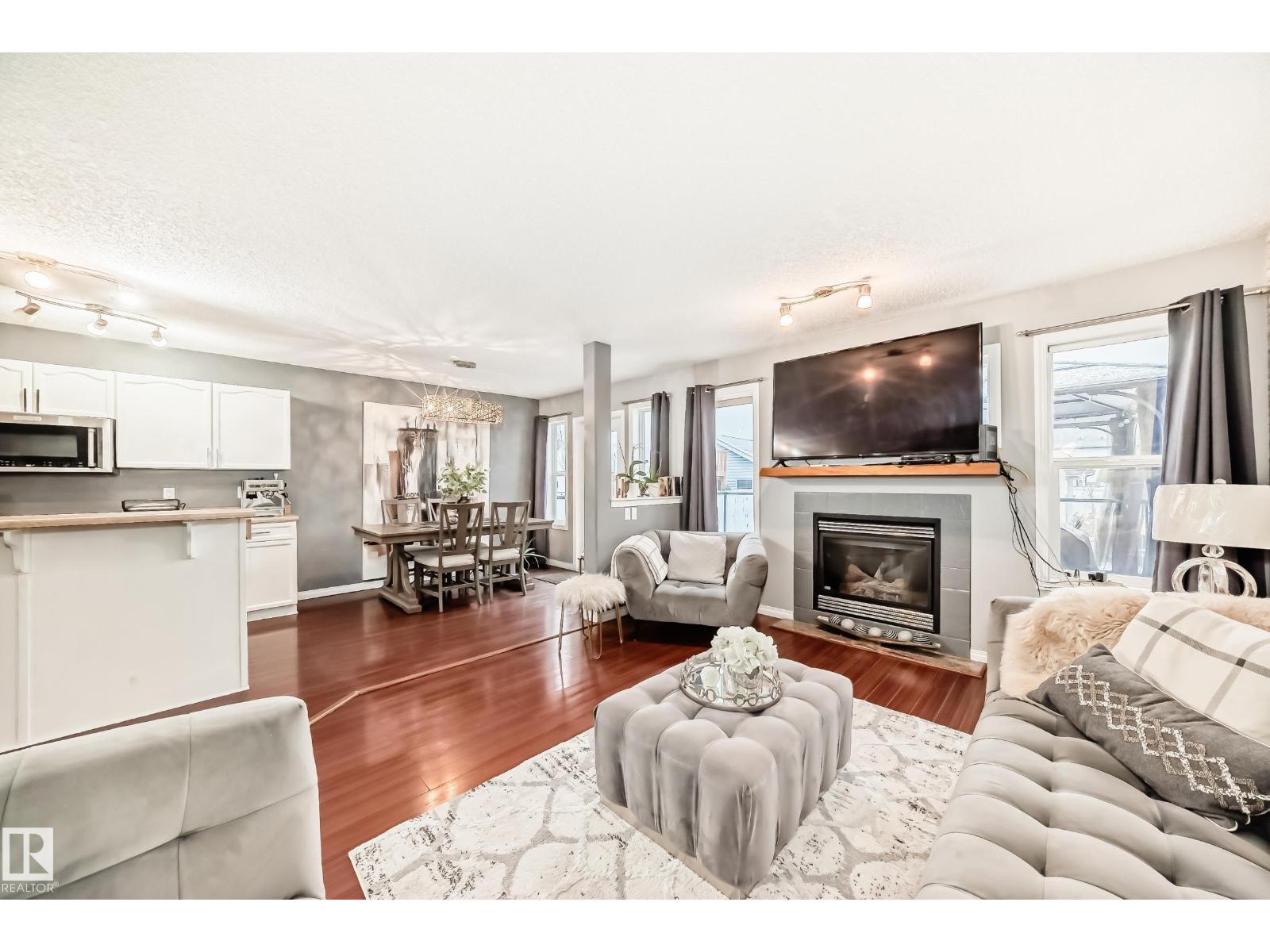 5819 Sutter Pl Nw, Edmonton, AB - Indoor Photo Showing Living Room With Fireplace