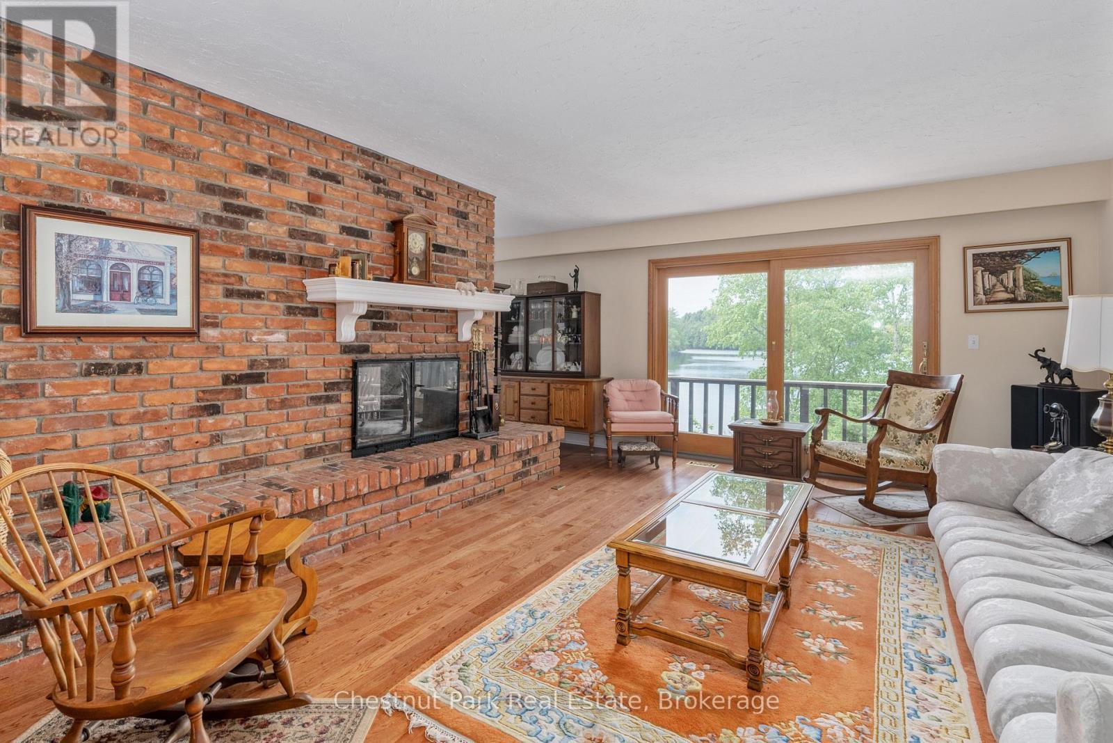 652 North Waseosa Lake Road, Huntsville (Chaffey), ON - Indoor Photo Showing Living Room With Fireplace