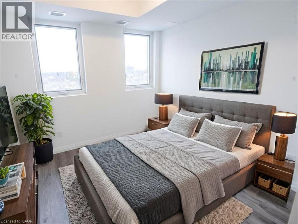 Bedroom with wood finished floors and baseboards - 108 Garment Street Unit# 606, Kitchener, ON - Indoor Photo Showing Bedroom