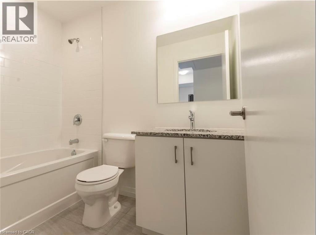 Bathroom featuring tub / shower combination, vanity, and light tile patterned floors - 108 Garment Street Unit# 606, Kitchener, ON - Indoor Photo Showing Bathroom