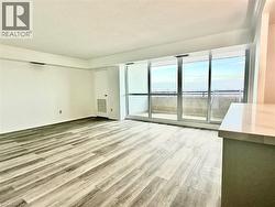 Unfurnished living room featuring light wood-style floors and a textured ceiling -