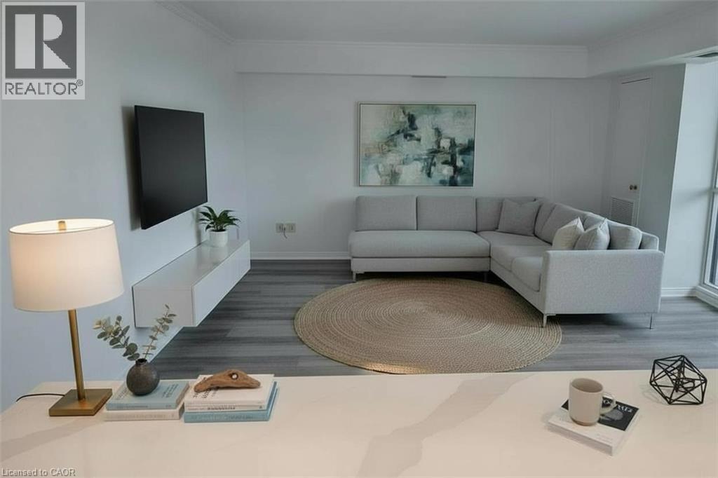 Living room with ornamental molding and wood finished floors - 389 Dundas Street Unit# 1506, London, ON - Indoor