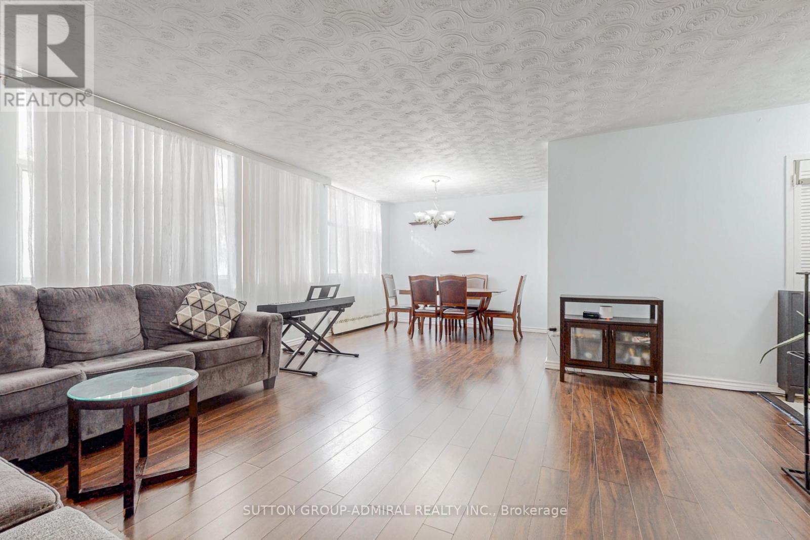 View of living and dining from the bedroom - 209 - 2245 Eglinton Avenue E, Toronto, ON - Indoor Photo Showing Living Room