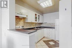 Kitchen with ceramic floor and backsplash -