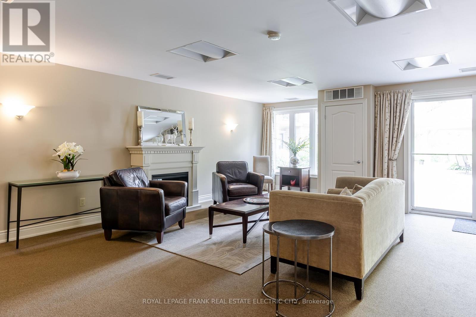 105 - 869 Clonsilla Avenue, Peterborough (Otonabee Ward 1), ON - Indoor Photo Showing Living Room With Fireplace