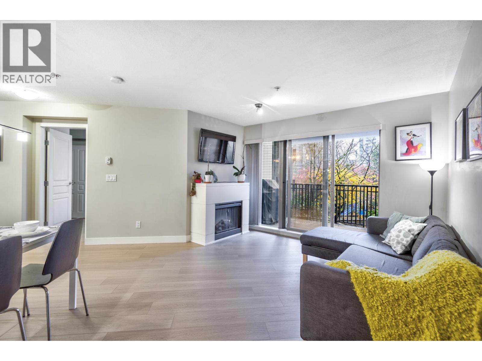 209 2088 Beta Avenue, Burnaby, BC - Indoor Photo Showing Living Room With Fireplace