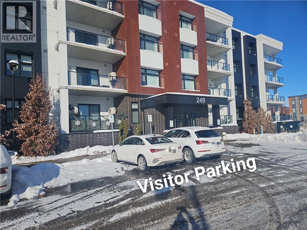 Snow covered property with a view of apartment building / complex and uncovered parking - 249 Grey Silo Road Unit# 301, Waterloo, ON - Outdoor With Balcony With Facade