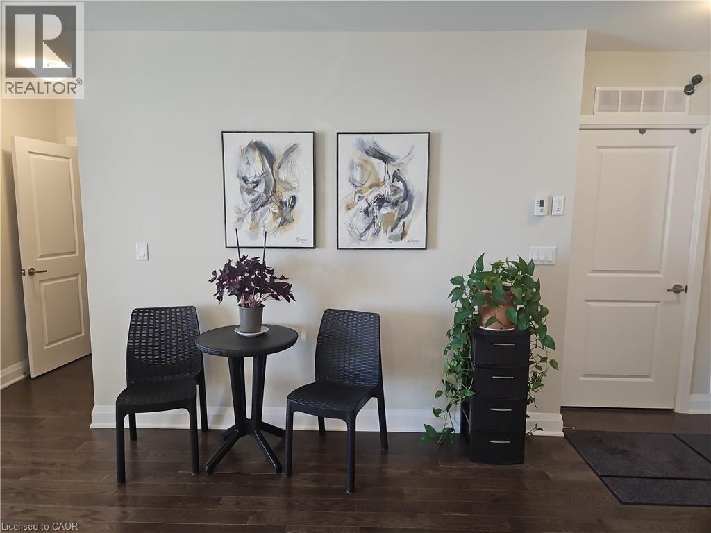 Living area with baseboards and dark wood-style floors - 249 Grey Silo Road Unit# 301, Waterloo, ON - Indoor