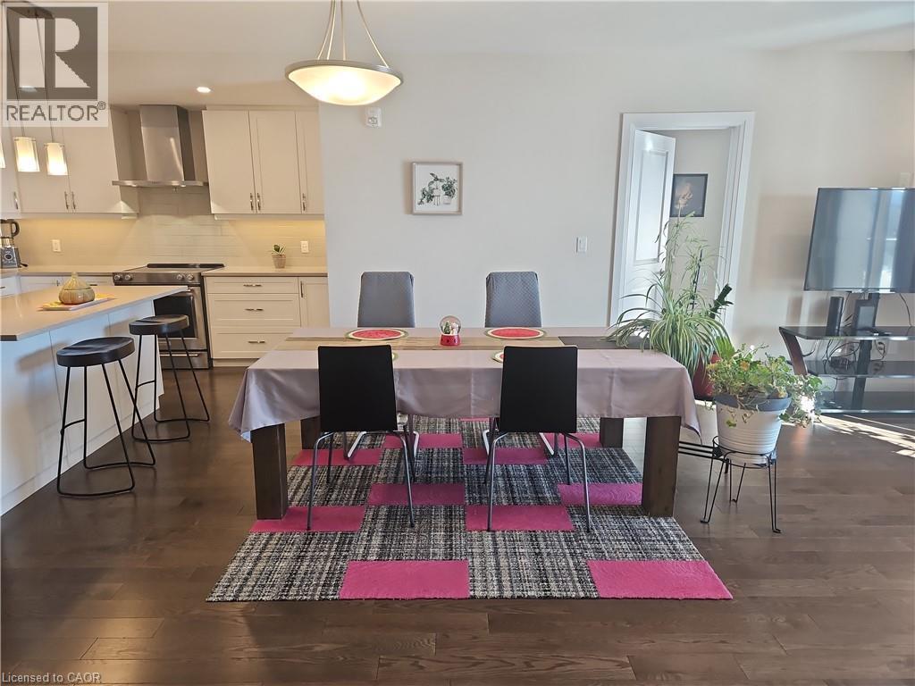 Dining area featuring dark wood-style floors and recessed lighting - 249 Grey Silo Road Unit# 301, Waterloo, ON - Indoor