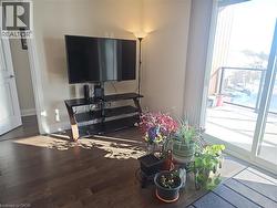 Living room featuring healthy amount of natural light and wood-type flooring -